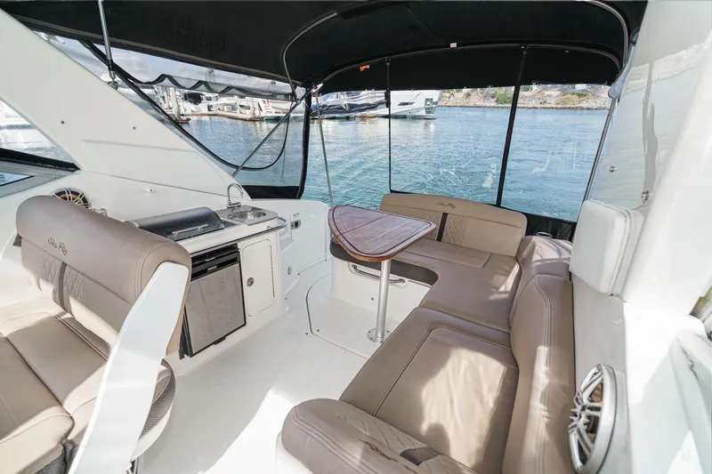 Slide: The Image of Interior of 2016 Sea Ray 280 Sundancer boat with seating and kitchenette. - 14