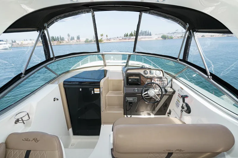 Slide: The Image of Interior view of 2016 Sea Ray 280 Sundancer boat cockpit with steering wheel and controls. - 17