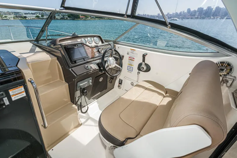 Slide: The Image of Interior view of 2016 Sea Ray 280 Sundancer boat cockpit with steering wheel and controls. - 19