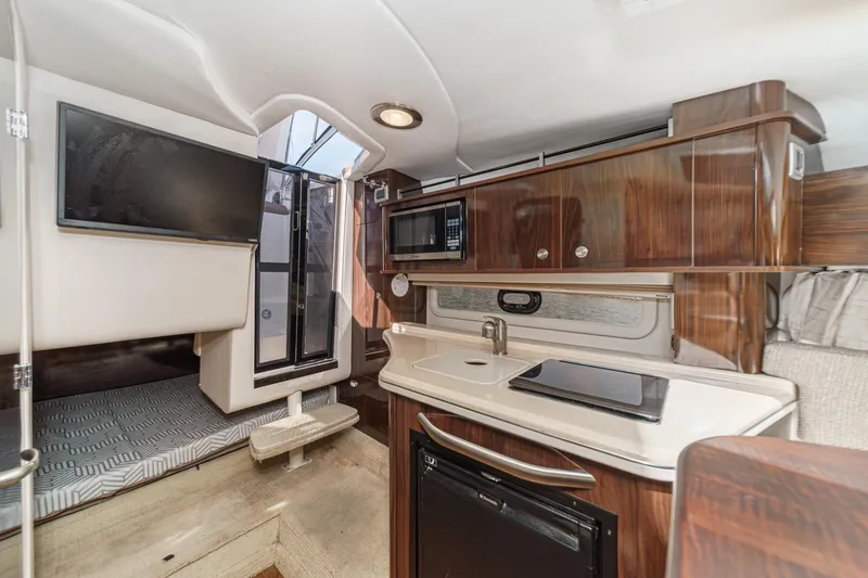 Slide: The Image of Interior of 2016 Sea Ray 280 Sundancer with kitchenette and sleeping area. - 25