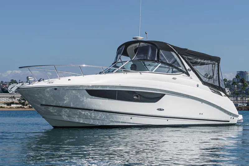 Slide: The Image of 2016 Sea Ray 280 Sundancer boat on calm water, featuring sleek design and black canopy. - 7