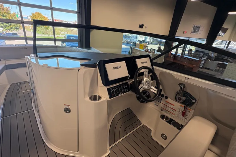 Slide: The Image of 2025 Sea Ray SDX 270 Surf boat interior with modern dashboard and steering wheel. - 14