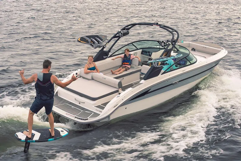 Slide: The Image of 2025 Sea Ray SDX 270 Surf boat interior at showroom, featuring luxurious seating and modern design. - 2