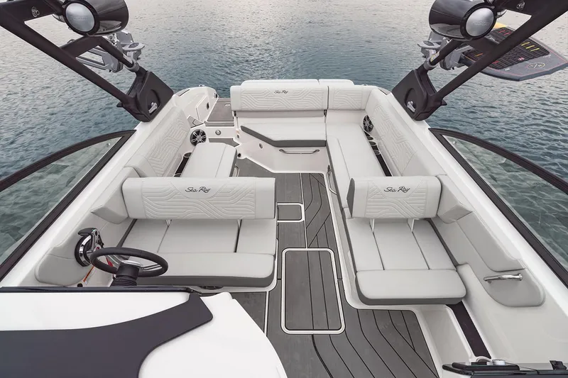 Slide: The Image of 2025 Sea Ray SDX 270 Surf boat interior with white seating and modern design. - 5