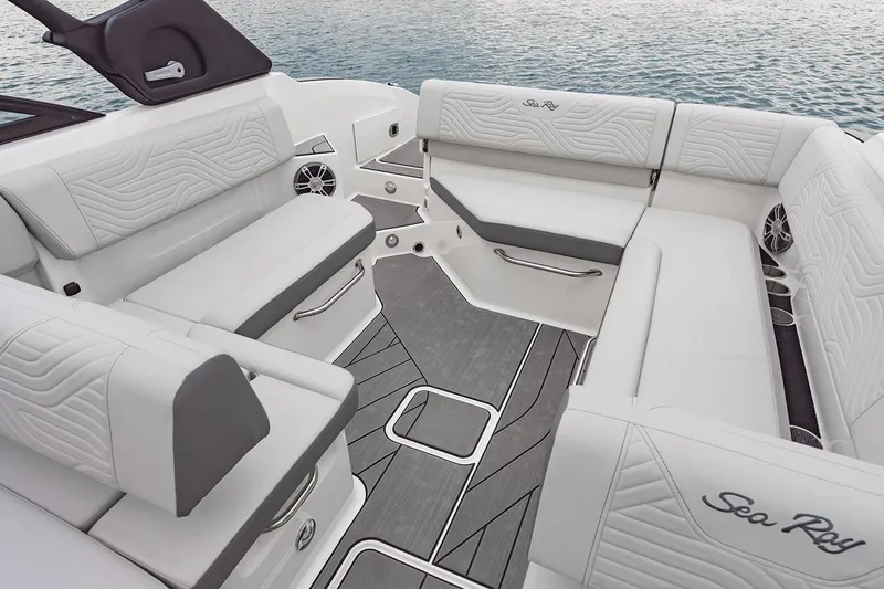 Slide: The Image of 2025 Sea Ray SDX 270 Surf boat interior with open storage compartment and seating area. - 7