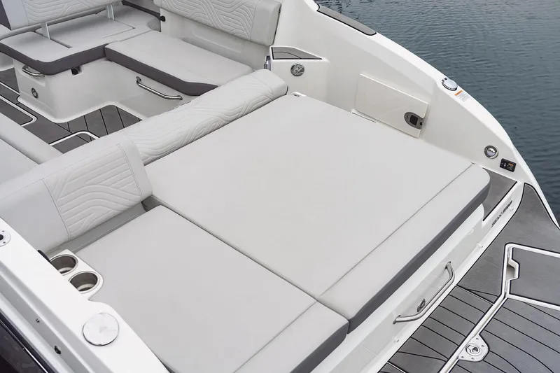 Slide: The Image of 2025 Sea Ray SDX 270 Surf boat interior with open storage compartment and helm controls. - 9