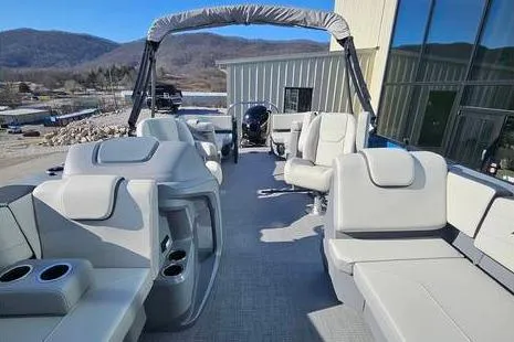 Slide: The Image of 2025 Starcraft GX 22 R DH Sport boat interior with modern seating and cup holders. - 6