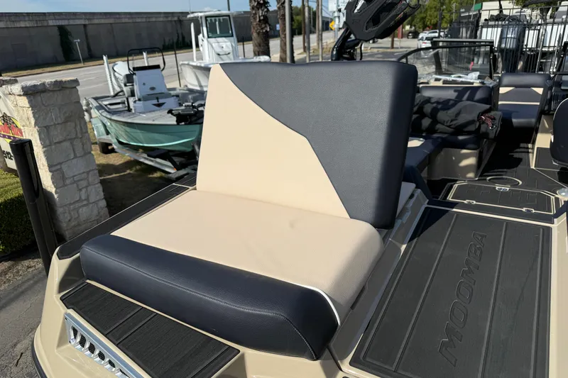 Slide: The Image of 2026 Moomba Mojo boat seat with beige and black upholstery, showcasing sleek design. - 10