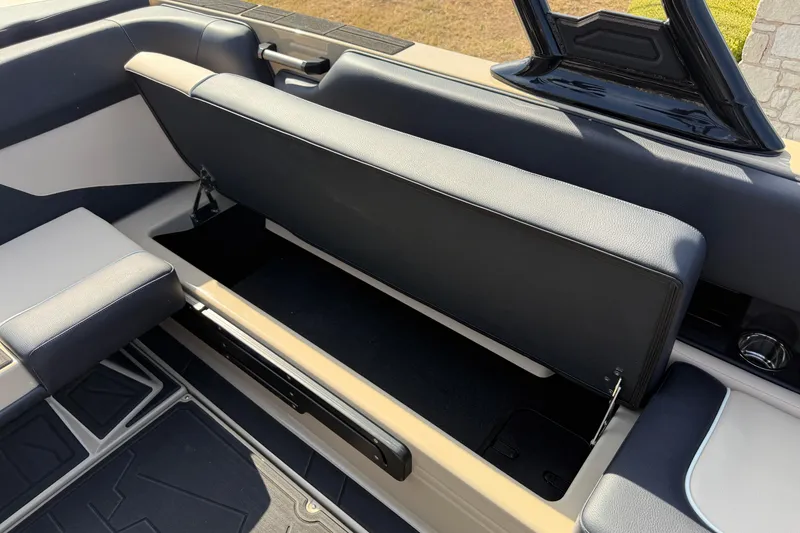 Slide: The Image of 2026 Moomba Mojo boat interior with open storage compartment and sleek seating design. - 15
