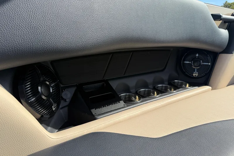 Slide: The Image of 2026 Moomba Mojo interior with cup holders and speakers, featuring sleek design elements. - 16