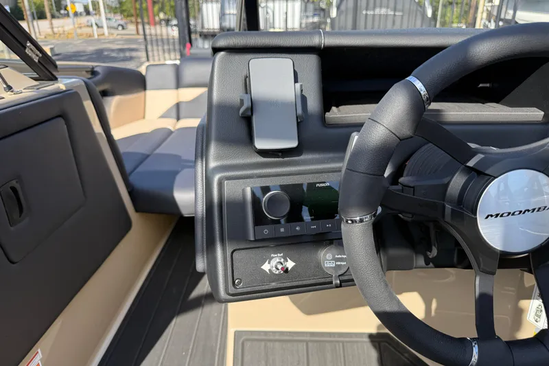 Slide: The Image of 2026 Moomba Mojo boat dashboard with steering wheel and control panel. - 24