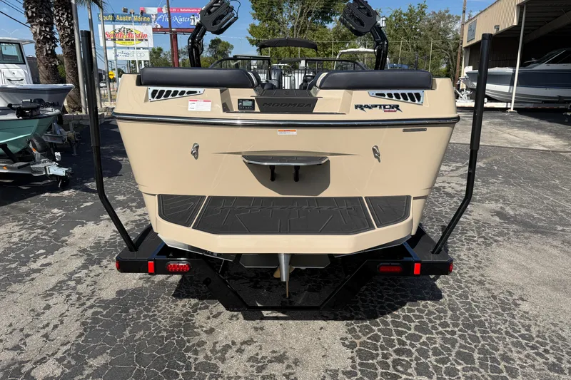 Slide: The Image of 2026 Moomba Mojo boat rear view, featuring Raptor engine, parked at South Austin Marine. - 3