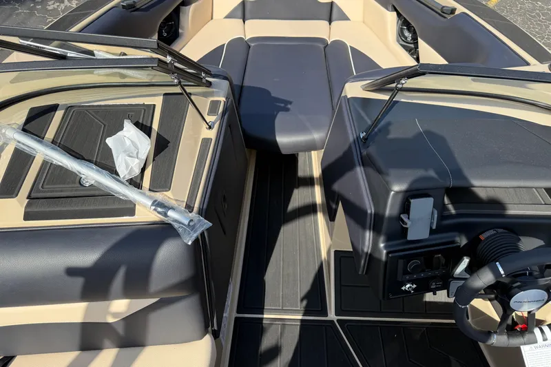 Slide: The Image of 2026 Moomba Mojo boat interior with steering wheel and seating area. - 30