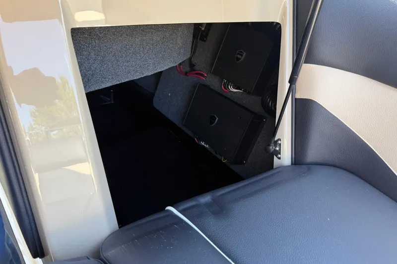 Slide: The Image of 2026 Moomba Mojo interior storage compartment with electronic components visible. - 33