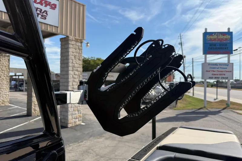 Slide: The Image of 2026 Moomba Mojo boat with a wakeboard rack in a dealership parking lot. - 36