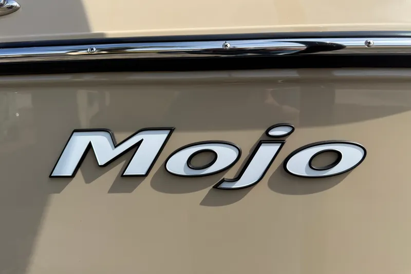 Slide: The Image of 2026 Moomba Mojo boat logo on beige surface with chrome trim. - 38