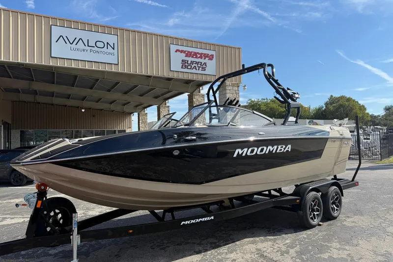 Slide: The Image of 2026 Moomba Mojo boat on trailer outside Avalon Luxury Pontoons dealership. - 4