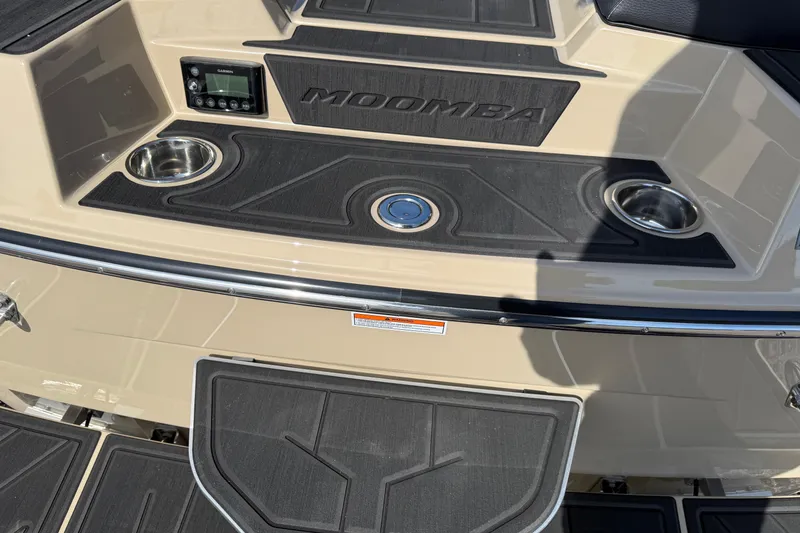 Slide: The Image of 2026 Moomba Mojo boat deck with cup holders and control panel. - 7