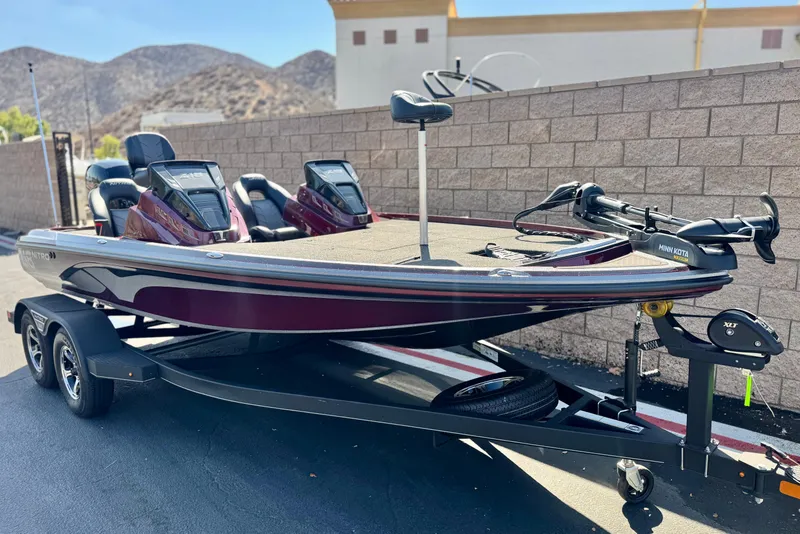 Slide: The Image of 2023 Nitro Z18 boat on trailer, parked outdoors, featuring dual consoles and trolling motor. - 1