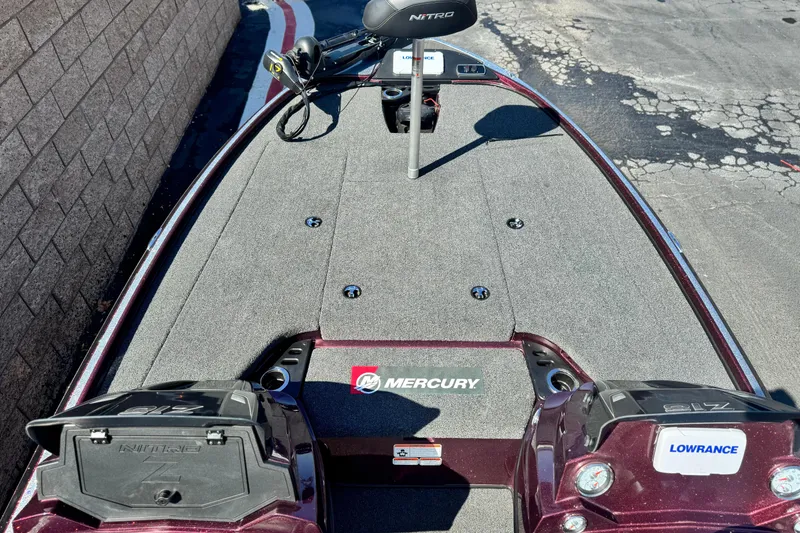 Slide: The Image of 2023 Nitro Z18 boat deck with Mercury and Lowrance equipment, parked on pavement. - 10