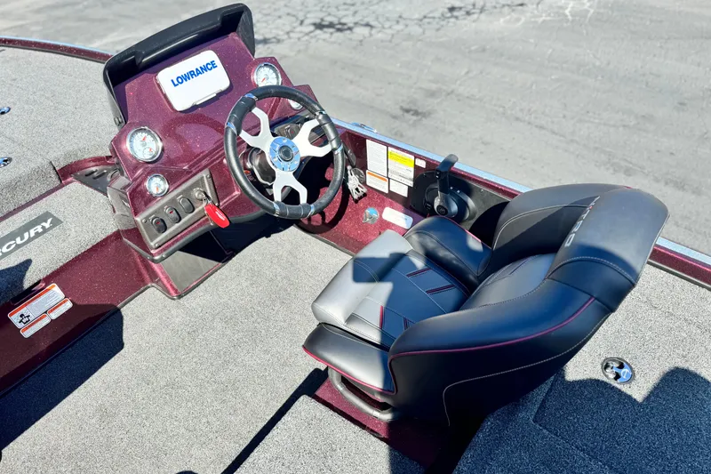 Slide: The Image of 2023 Nitro Z18 boat cockpit with steering wheel, Lowrance display, and comfortable seating. - 17