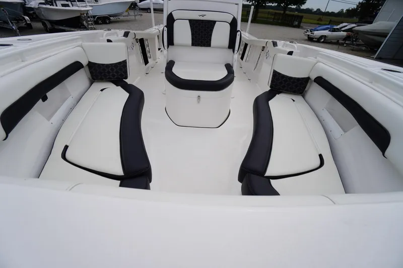 Slide: The Image of 2021 Tidewater 256 CC Adventure boat interior with cushioned seating and storage. - 11