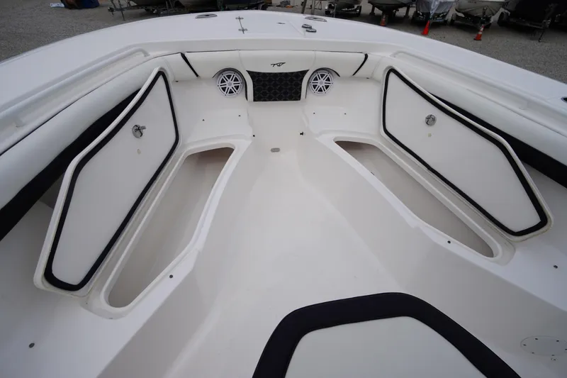 Slide: The Image of 2021 Tidewater 256 CC Adventure boat interior with storage compartments and speakers. - 13