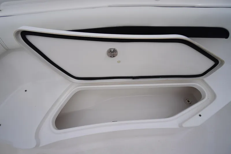 Slide: The Image of 2021 Tidewater 256 CC Adventure boat storage compartment, open and empty. - 14