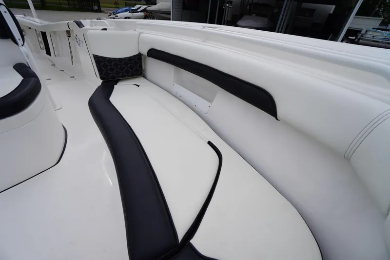 Slide: The Image of 2021 Tidewater 256 CC Adventure boat interior with white and black seating. - 16
