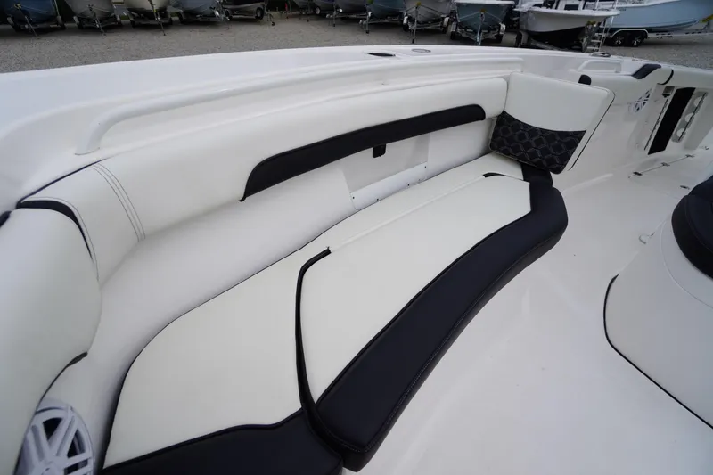 Slide: The Image of 2021 Tidewater 256 CC Adventure boat interior with white and black seating. - 17
