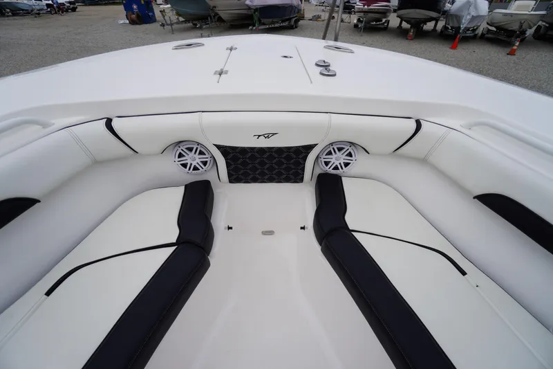 Slide: The Image of 2021 Tidewater 256 CC Adventure boat interior with white and black seating. - 19