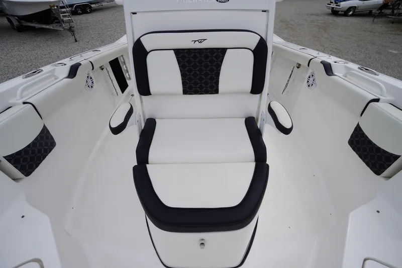 Slide: The Image of 2021 Tidewater 256 CC Adventure boat interior with cushioned seating and armrests. - 25