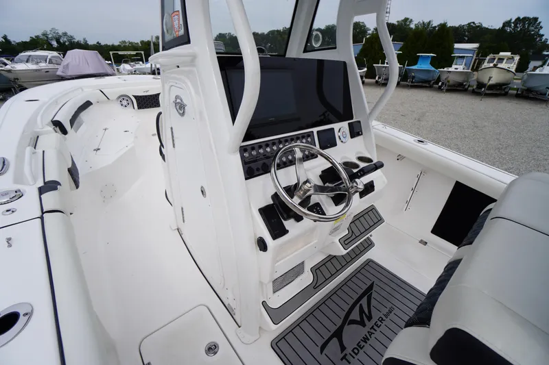 Slide: The Image of 2021 Tidewater 256 CC Adventure boat interior with modern helm and seating. - 26