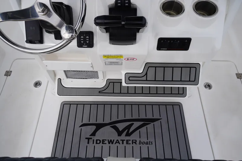 Slide: The Image of 2021 Tidewater 256 CC Adventure boat cockpit with steering wheel and control panel. - 31