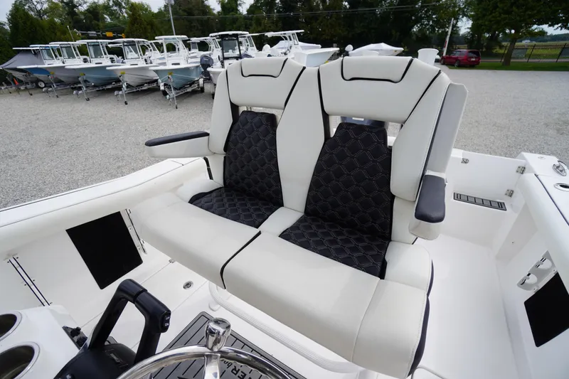 Slide: The Image of 2021 Tidewater 256 CC Adventure boat with dual cushioned seats and sleek design. - 34