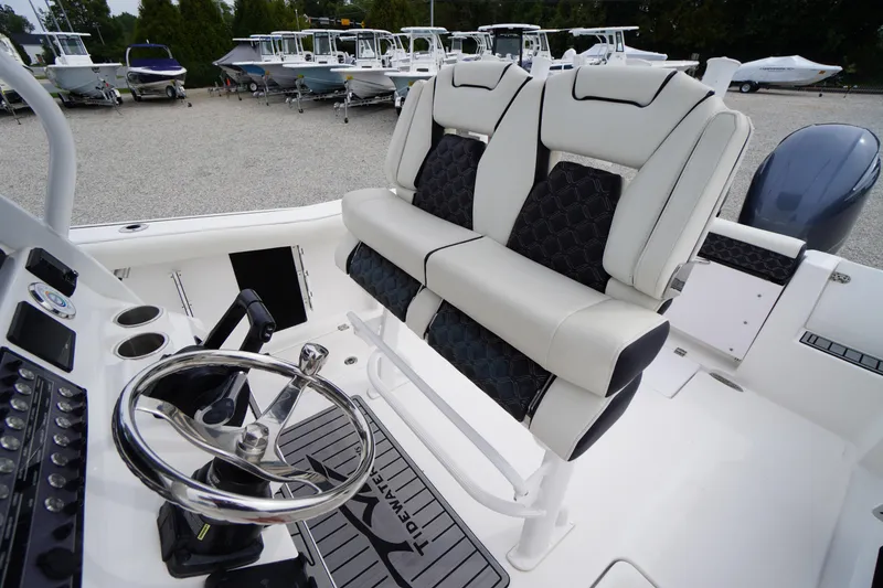 Slide: The Image of 2021 Tidewater 256 CC Adventure boat interior with dual seats and steering wheel. - 36
