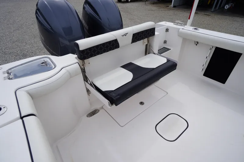Slide: The Image of 2021 Tidewater 256 CC Adventure boat interior with foldable seat and dual engines. - 42