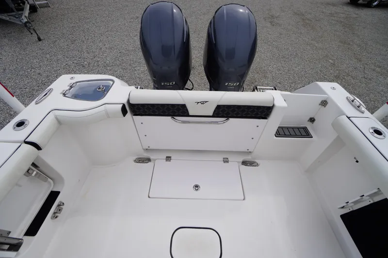 Slide: The Image of 2021 Tidewater 256 CC Adventure boat interior with dual engines and seating area. - 43