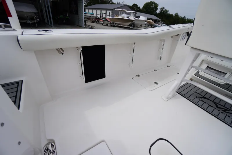 Slide: The Image of 2021 Tidewater 256 CC Adventure boat interior, featuring spacious deck and storage compartments. - 45
