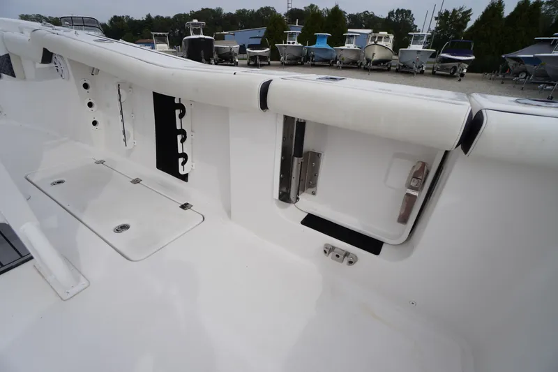 Slide: The Image of 2021 Tidewater 256 CC Adventure boat interior with storage compartments and seating. - 46
