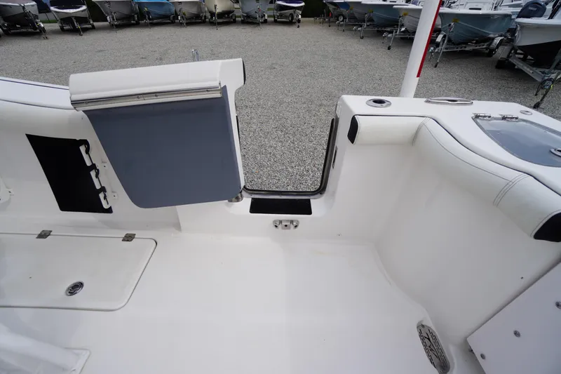 Slide: The Image of 2021 Tidewater 256 CC Adventure boat interior with open transom door. - 47