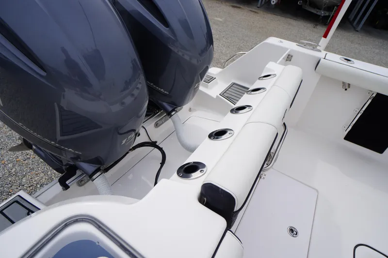 Slide: The Image of 2021 Tidewater 256 CC Adventure boat with dual engines and rod holders. - 48