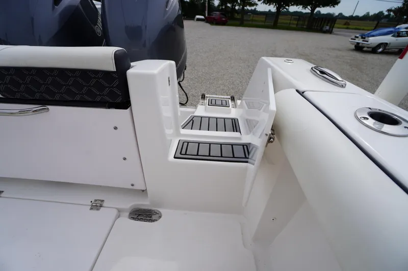 Slide: The Image of 2021 Tidewater 256 CC Adventure boat interior with seating and step details. - 49