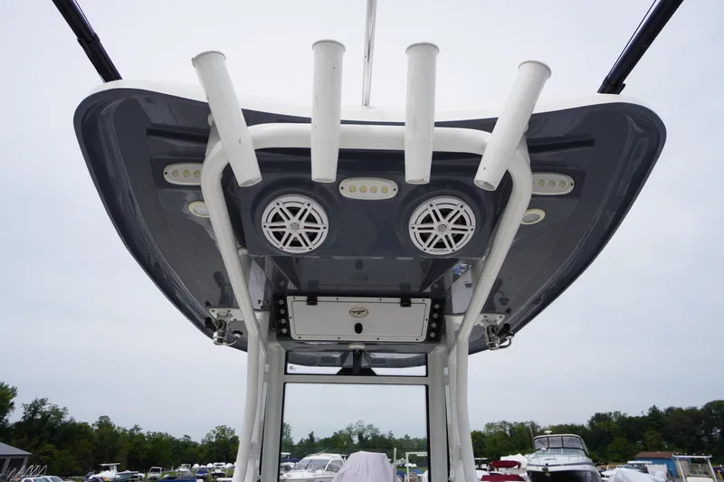 Slide: The Image of 2021 Tidewater 256 CC Adventure boat with rod holders and speakers on the T-top. - 50