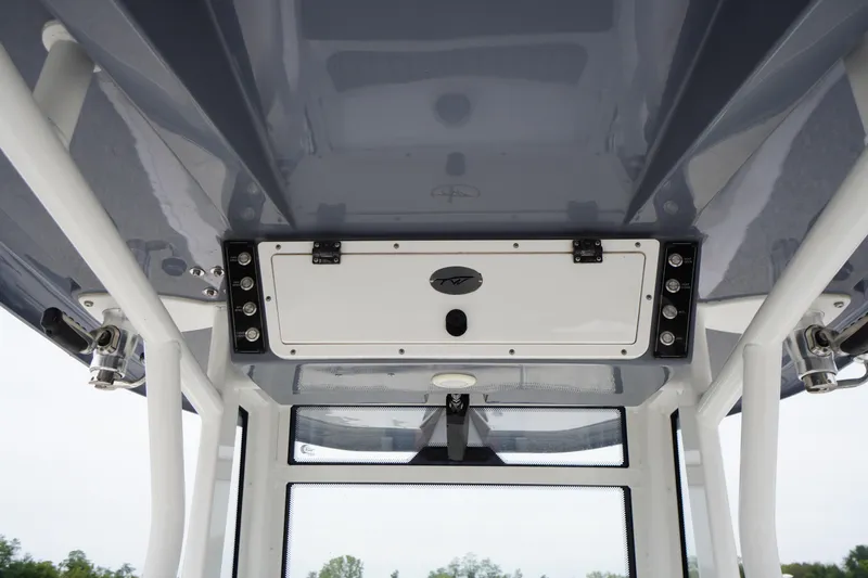 Slide: The Image of 2021 Tidewater 256 CC Adventure boat console with storage compartment and overhead view. - 52
