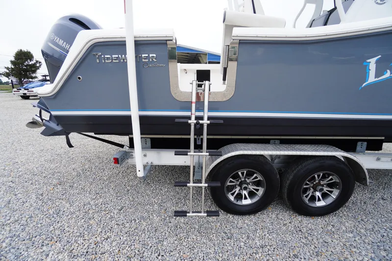 Slide: The Image of 2021 Tidewater 256 CC Adventure boat on trailer with ladder and Yamaha engine. - 54