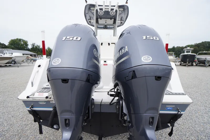 Slide: The Image of 2021 Tidewater 256 CC Adventure boat with dual Yamaha 150 engines, rear view. - 56
