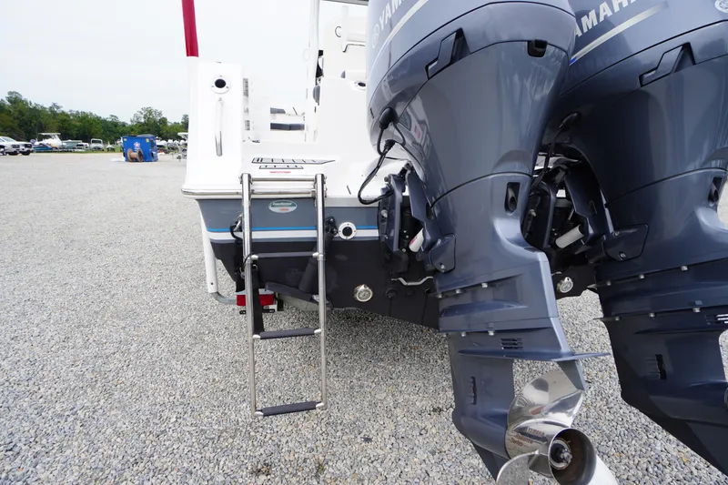 Slide: The Image of 2021 Tidewater 256 CC Adventure boat with dual Yamaha outboard motors and ladder. - 61