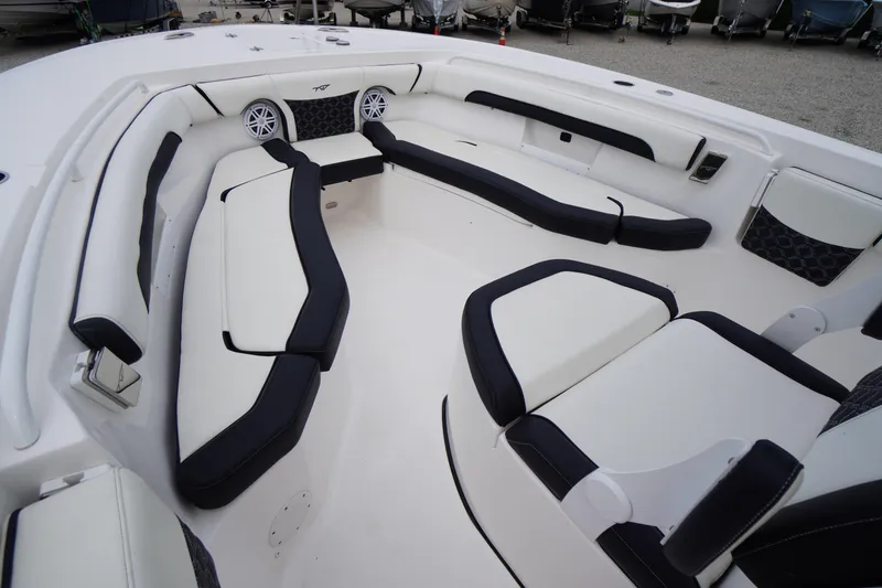 Slide: The Image of 2021 Tidewater 256 CC Adventure boat interior with cushioned seating and speakers. - 7