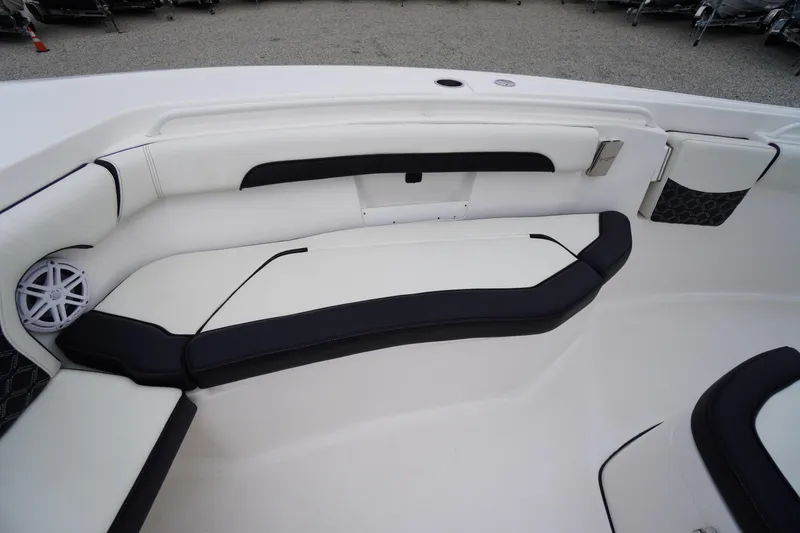 Slide: The Image of 2021 Tidewater 256 CC Adventure boat interior with cushioned seating and speaker. - 8